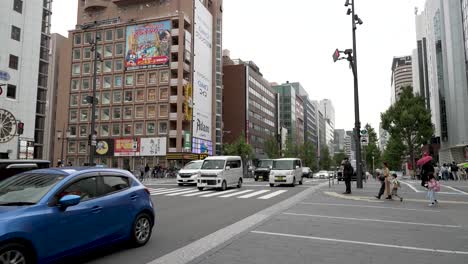 Traffic-Going-Past-Along-Midosuji-Avenue-In-Osaka-On-Overcast-Day