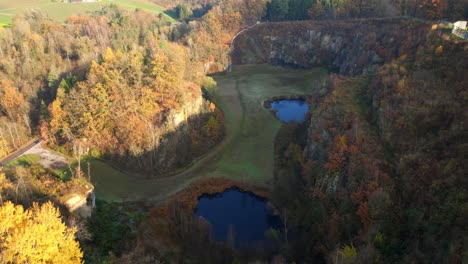 -Mauthausen,-Upper-Austria---An-Encompassing-Perspective-of-the-Wiener-Graben-Quarry---Aerial-Pullback