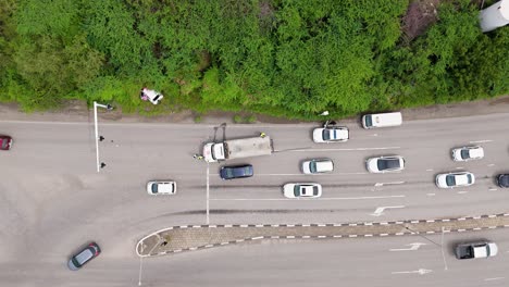 Cars-swerve-around-crash-accident-site-blocking-traffic-on-tropical-island