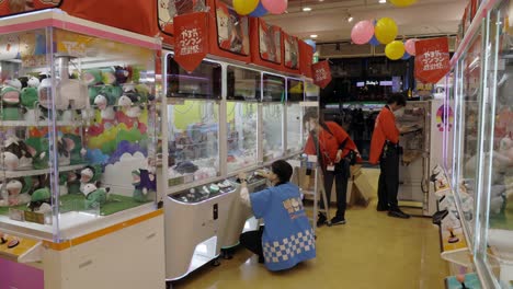 Workers-in-Pachinko-Game-Entertainment-Center,-Shibuya,-Tokyo,-Japan