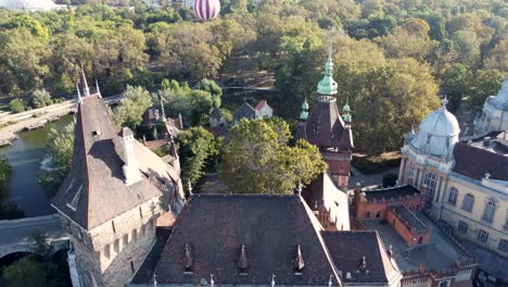 Drone-flight-over-iconic-Vajdahunyad-Castle-in-Budapest-City-Park,-Hungary