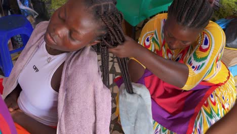 Hairstylists-towel-drying-and-working-with-young-woman’s-hair-extensions