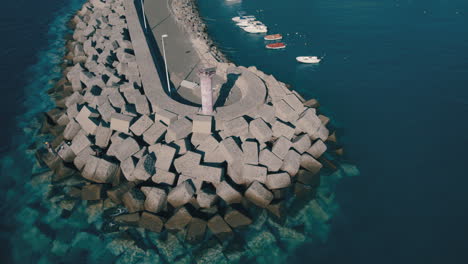 Orbital-aerial-view-of-the-dock-of-the-city-of-La-Aldea-de-San-Nicolas,-on-the-island-of-Gran-Canaria-and-on-a-sunny-day