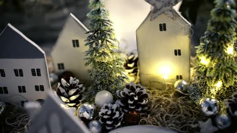 Hand-crafted-Christmas-scenery-with-houses,-trees,-lights-and-on