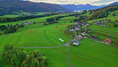An-Aerial-Shot-Of-A-Mountainous-Landscape-And-A-Small-Village-In-Austria