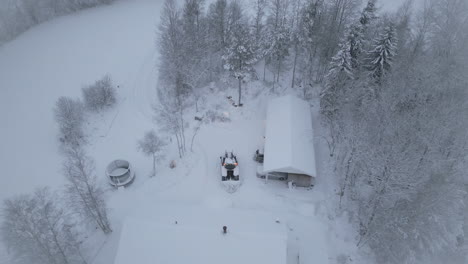 Tractor-plows-snow-from-private-house.-Aerial-circling