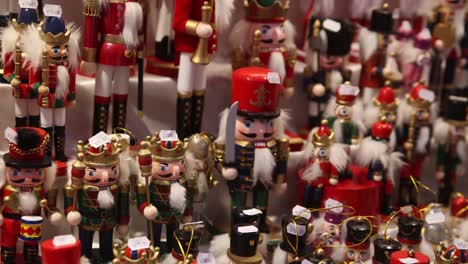 panning-shot-of-toy-wooden-nutcrackers-in-a-shop-at-heidelberg,-germany-at-a-Festive-Christmas-market-in-Europe