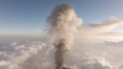 Aerial-view-of-a-tall-smoke-cloud-rising-from-the-Fuego-volcano,-in-Guatemala