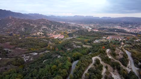 Drone-travel-a-mountain-road-on-a-Mediterranean-plateau-surrounded-by-mountains