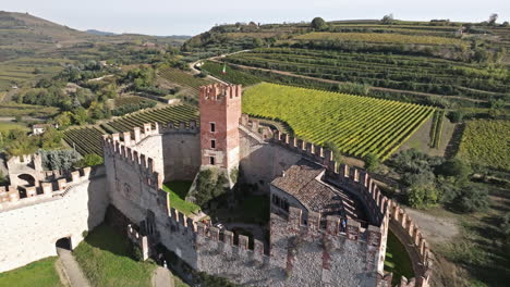 Castillo-Medieval-De-Scaliger-Con-Viñedos-Y-Paisaje-Rural-Al-Fondo-En-Soave,-Italia