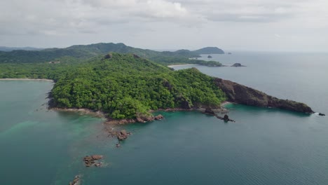 A-4K-drone-shot-of-Punta-Sabana-Point-and-the-Mirador-Conchal-Peninsula-next-to-Puerto-Viejo-and-Playa-Conchal,-or-“Shell-Beach”,-along-the-north-western-coast-of-Costa-Rica