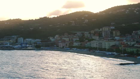 Scenic-wide-view-of-peaceful-Italian,-mountainside-comune,-Varazze,-facing-serene-ocean-waters-during-dusk