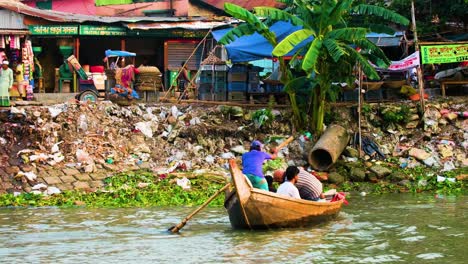 Locals-navigating-a-river-amidst-environmental-challenges-in-Bangladesh---Passengers-traveling-through-boats-in-Bangladesh