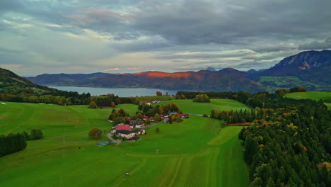 Countryside-with-vast-green-meadows-next-to-lake-Atter,-Attersee,-Austria
