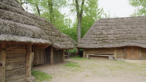 Ancient-Wooden-Slavic-Houses-in-Biskupin-settlement,-Poland---pan-right-shot