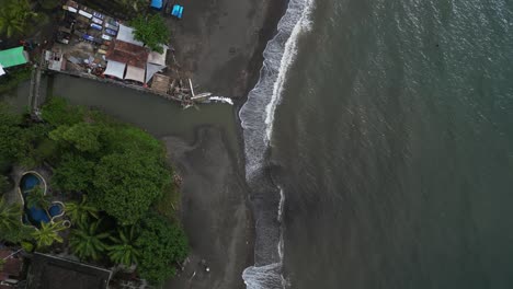 Birds-eye-view-of-a-shoreline-with-boats-and-trees-in-the-North-of-Bali,-Indonesia