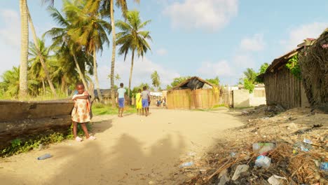 black-people-walking-in-sandy-street-road-in-remote-fisherman-village-of-africa