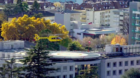 A-helicopter-taking-of-the-heliport-of-the-hospital-in-Meran---Merano-on-a-sunny-but-windy-autumn-day