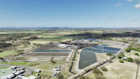 A-fishery-industry's-collection-basin-seen-from-a-drone,-aerial-static-shot