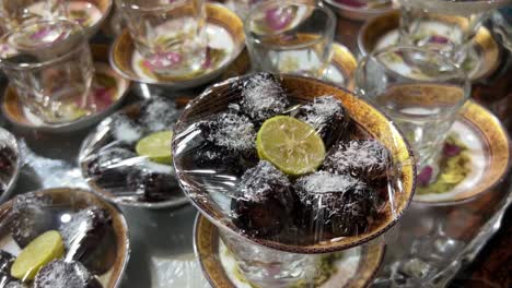 Street-food-in-Iran-Tehran-night-tea-hot-drink-sold-with-dates-coconut-powder-design-garnish-dishes-filled-with-walnut-in-cold-city-urban-life-people-living-healthy-nightlife-islamic-country-dessert