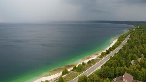 Aerial-view-Georgian-Bay-beach,-empty-road-pan-left-by-drone,-Canada