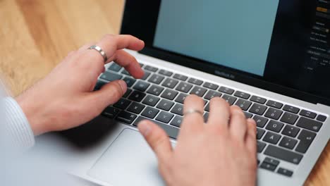 Over-the-Shoulder-View:-Man's-Hand-Typing-on-MacBook-Keyboard