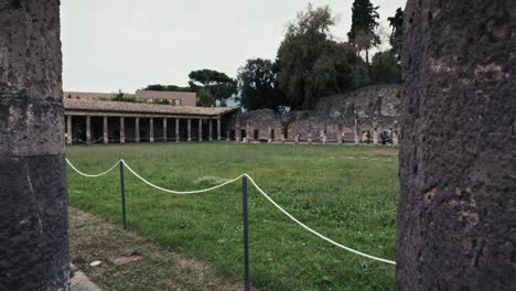 Los-Turistas-Exploran-Los-Pacíficos-Cuarteles-De-Gladiadores,-La-Antigua-Pompeya,-Italia.