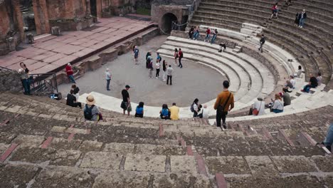 Lively-audience-of-tourists-at-the-Great-Theatre-of-Pompeii,-Italy