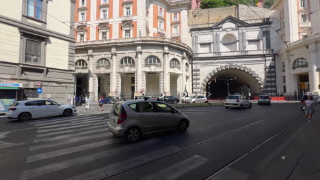 Traffic-at-city-intersection-near-tunnel-entrance,-urban-architecture---Neapol,-italy