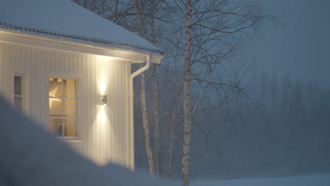 Snow-blizzard-wooden-cabin-house,-Heavy-Snowfall-At-Night