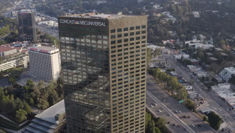 4K-cinematic-drone-shot-of-Comcast-NBC-Universal-headquarters-in-Universal-City-California-with-the-101-freeway-in-the-background