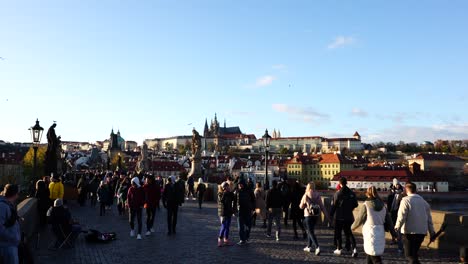 Crowded-Charles-bridge-with-tourists-and-view-to-city-during-golden-hour