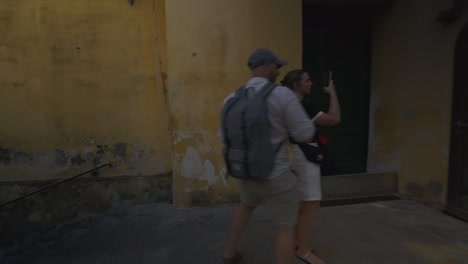 Amalfi-Positano-Italy-Immersive-Travel-Tourism-Mediterranean-Sea-Coast-Water-Europe,-Walking,-4K-|-Moving-Through-Busy-Tourist-Crowd-in-Shadows-Underneath-Mountainside-Dwellings-Above