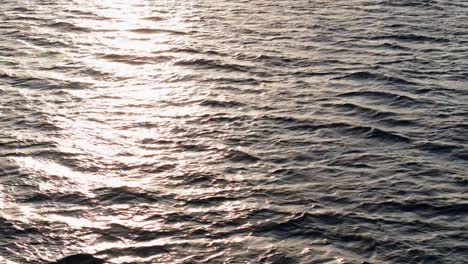 Aerial-parallax-of-sun-light-beam-across-open-ocean-water-textured-current