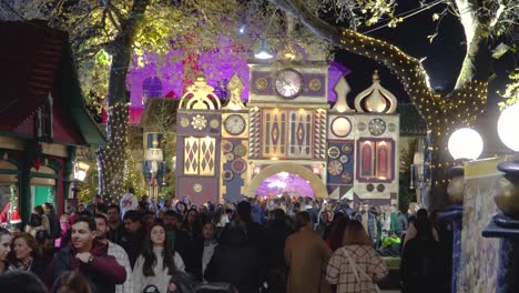 People-Walking-in-Christmas-Park-Entrance,-Mill-of-the-Elves-Park-in-Trikala-Greece