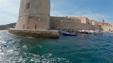 People-walking-around-the-old-town-fortress-in-Dubrovnik,-Croatia