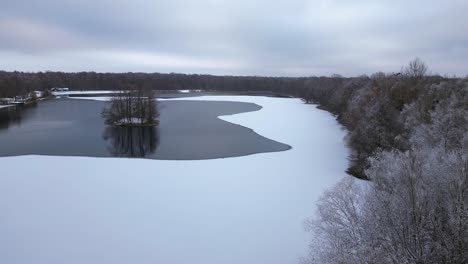 Winter-Snow-ice-lake-wood-forest-cloudy-sky-Germany