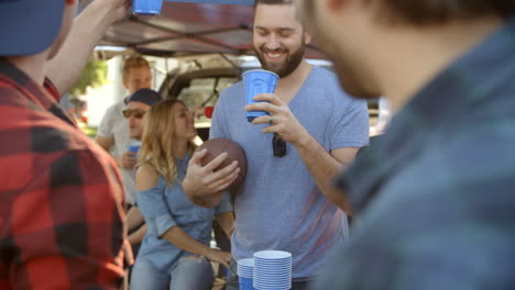 Slow-Motion-Shot-Of-Sports-Fans-Tailgating-In-Parking-Lot