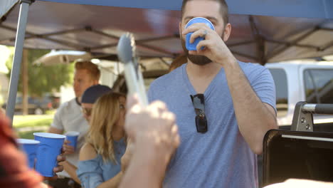 Slow-Motion-Shot-Of-Sports-Fans-Tailgating-In-Parking-Lot