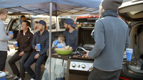 Slow-Motion-Shot-Of-Sports-Fans-Tailgating-In-Parking-Lot