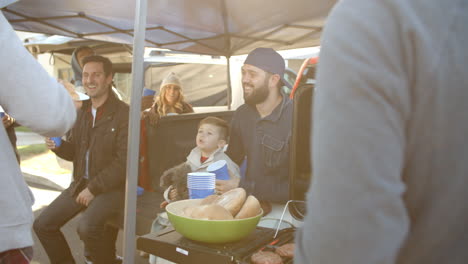 Slow-Motion-Shot-Of-Sports-Fans-Tailgating-In-Parking-Lot