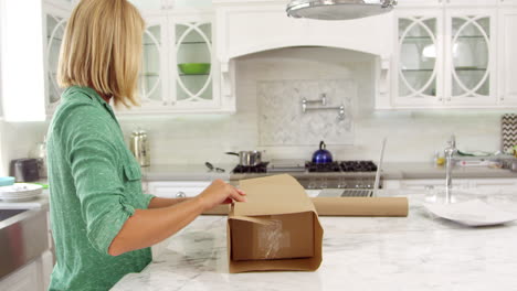Woman-At-Home-Wrapping-Package-For-Mailing-Shot-On-R3D