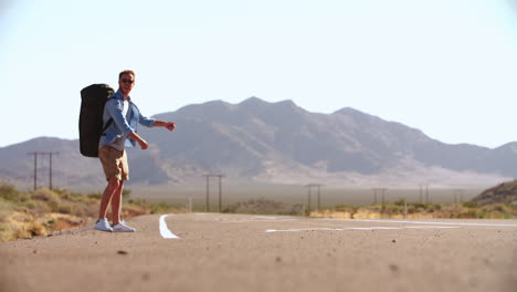 Two-Men-On-Vacation-Hitchhiking-Along-Road-Shot-On-R3D