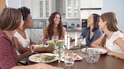 Female-friends-make-a-toast-and-eat-at-a-table,-slow-motion