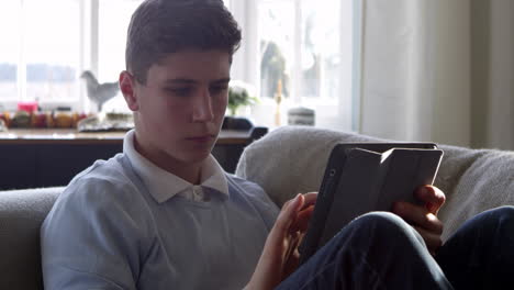 Teenage-Boy-Using-Digital-Tablet-At-Home-Shot-On-R3D