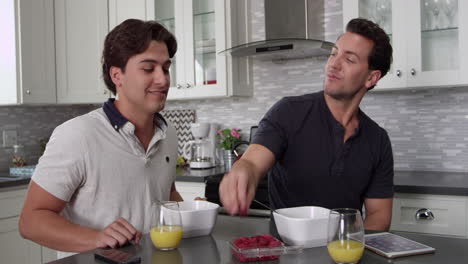 Man-feeds-his-boyfriend-a-raspberry-at-breakfast,-shot-on-R3D