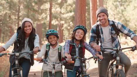 African-American-family-sitting-on-bikes-in-forest,-close-up