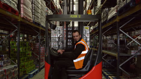Forklift-driver-moving-full-pallet-in-warehouse,-shot-on-R3D