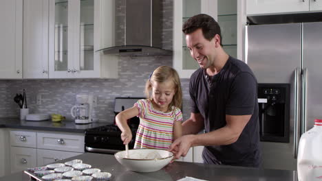 Caucasian-girl-and-dad-have-fun-preparing-cake-mix-mix,-shot-on-R3D