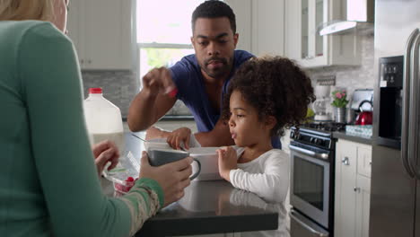Mixed-race-couple-and-daughter-eating-breakfast-in-kitchen,-shot-on-R3D